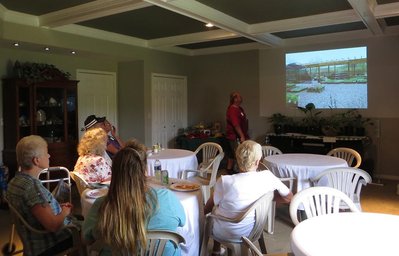 Audience engrossed in the Hallson Gardens history